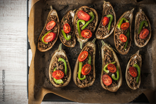 Stuffed eggplants with vegetables on the baking tray top view