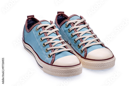 A pair of blue gumshoes with shoelace