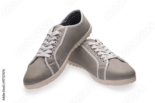 A pair of grey sports shoes with shoelace