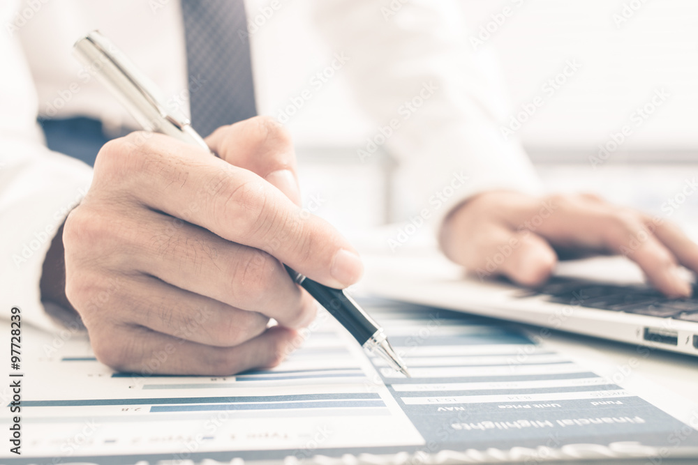 Fototapeta premium Man Analysis Business Report. Accounting