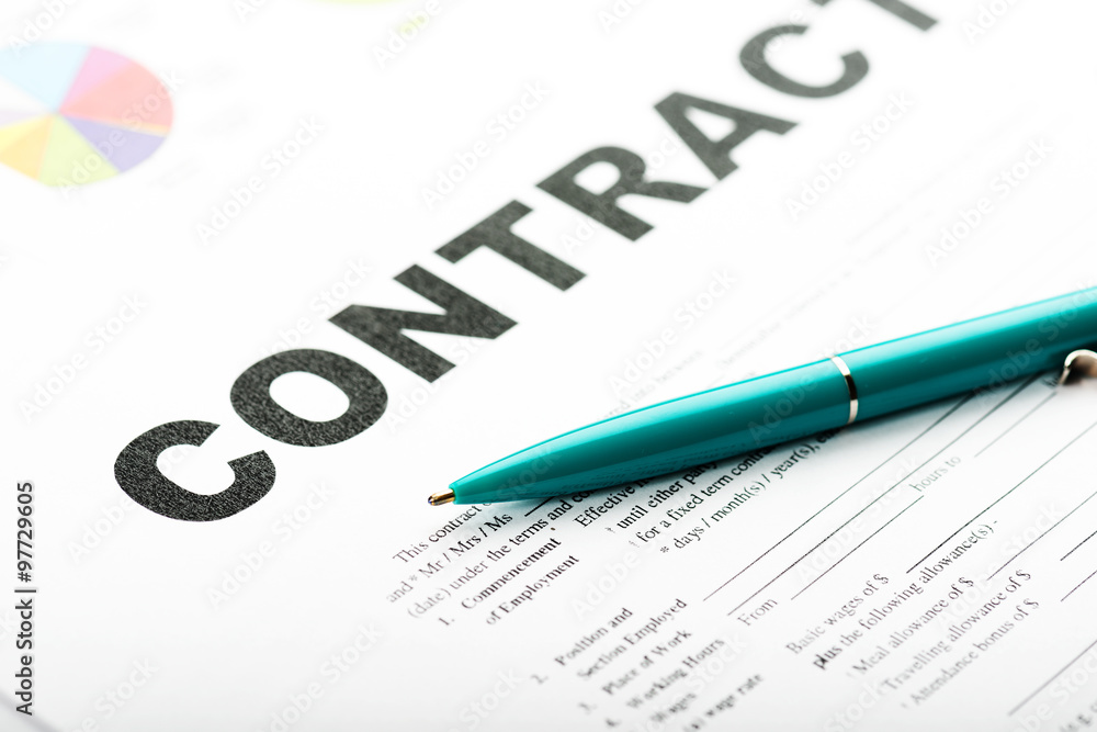Businesswoman's hand with pen signing a contract.