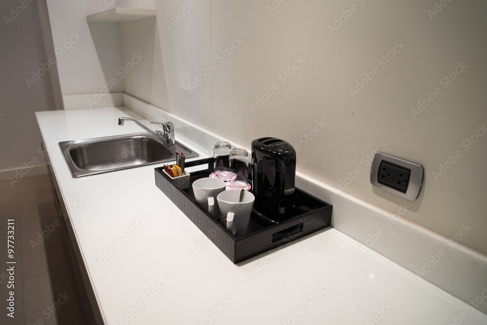 Coffeemaker and cup of coffee in kitchen interior Coffeemaker and cup of coffee in kitchen interior