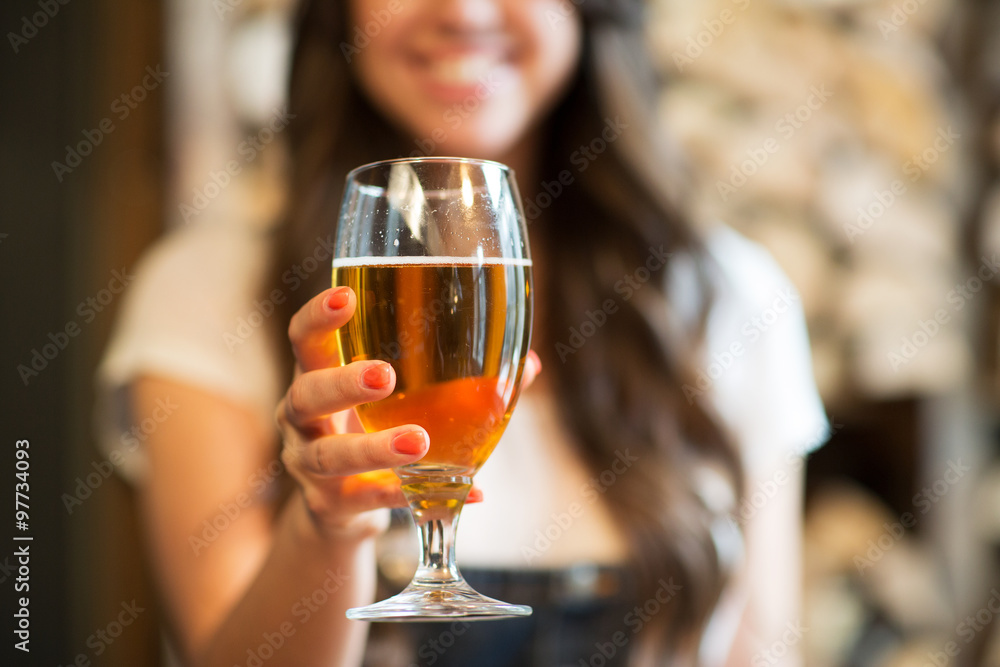 happy woman holding glass of draft lager beer