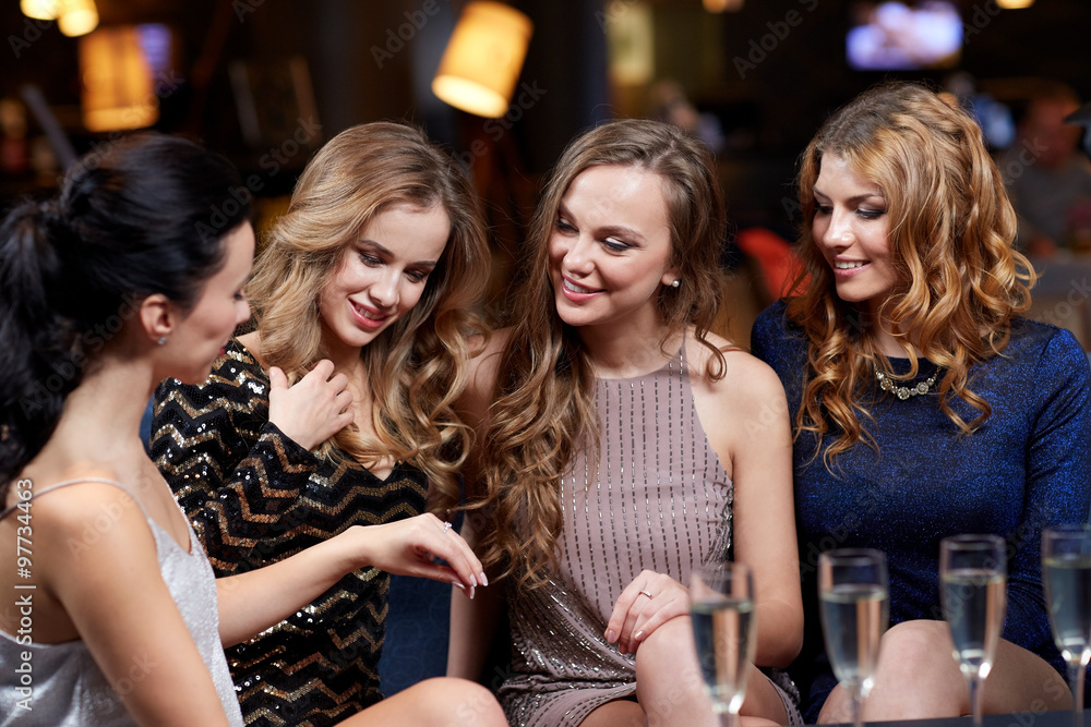 woman showing engagement ring to her friends