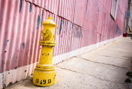 Yellow faucet at the streets of Valparaiso.