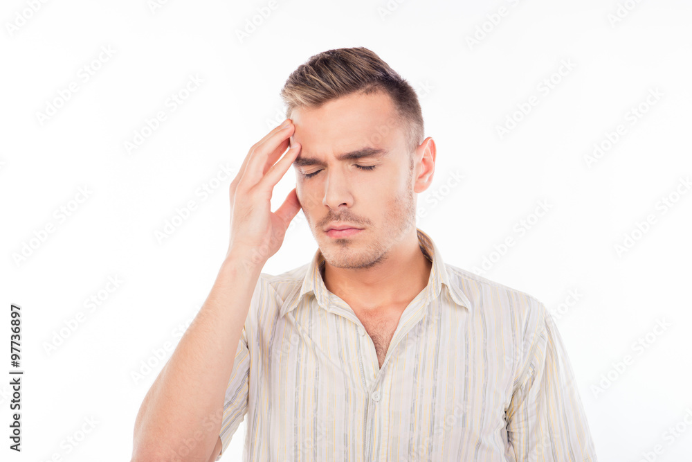 Handsome young man touching his head with one hand feeling stron Handsome young man touching his head with one hand feeling stron