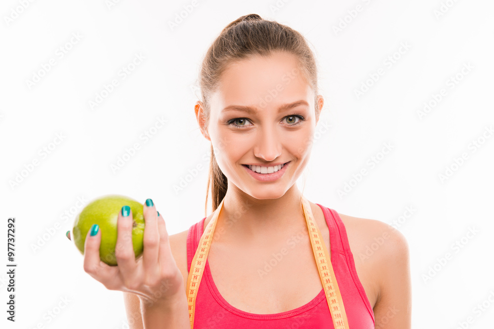 Pretty sporty girl with green apple in her hand Pretty sporty girl with green apple in her hand