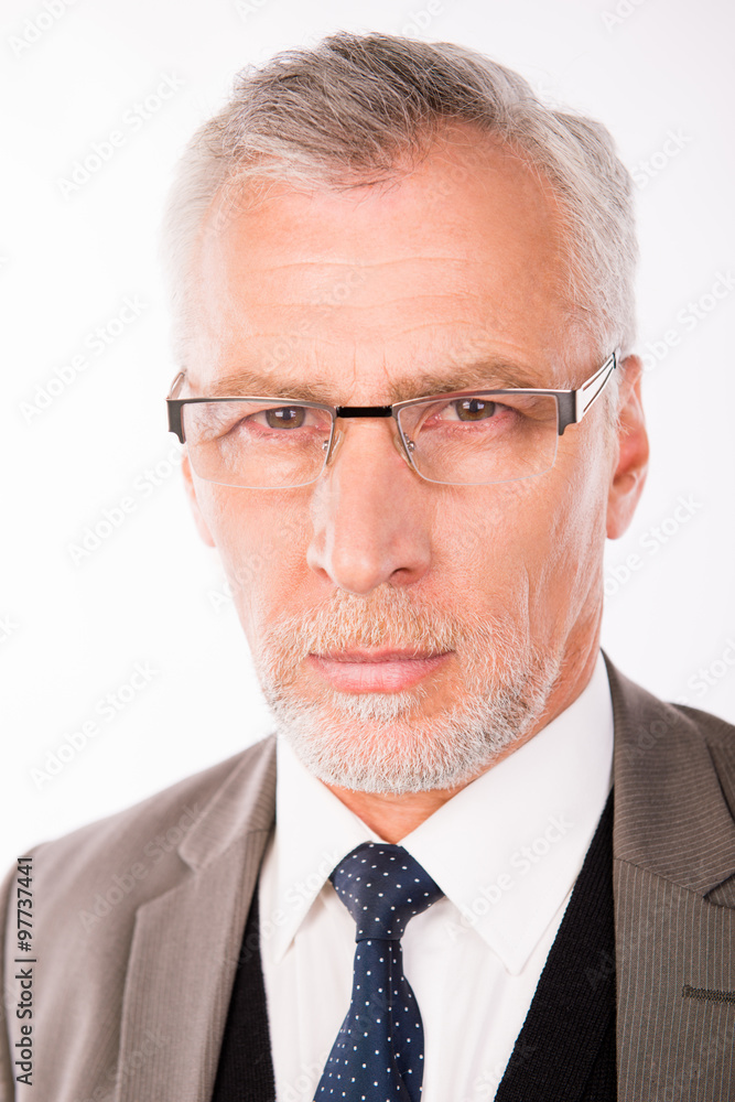 Portrait of old handsome businessman in an elegant suit with gla Portrait of old handsome businessman in an elegant suit with gla