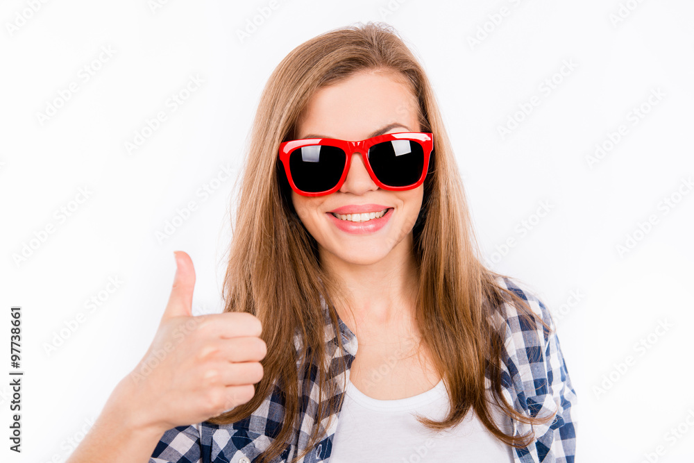 Funny girl in glasses with a red rim showing thumbs up Funny girl in glasses with a red rim showing thumbs up