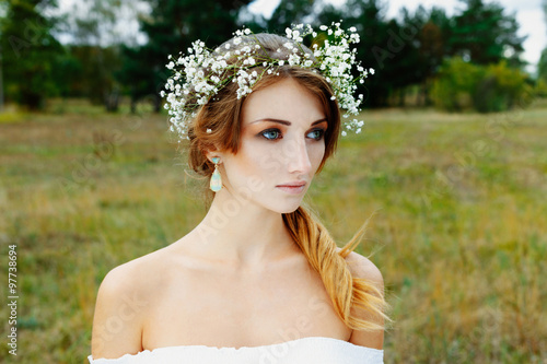 Close up portrait of woman face wearing floral white wreath outdoors