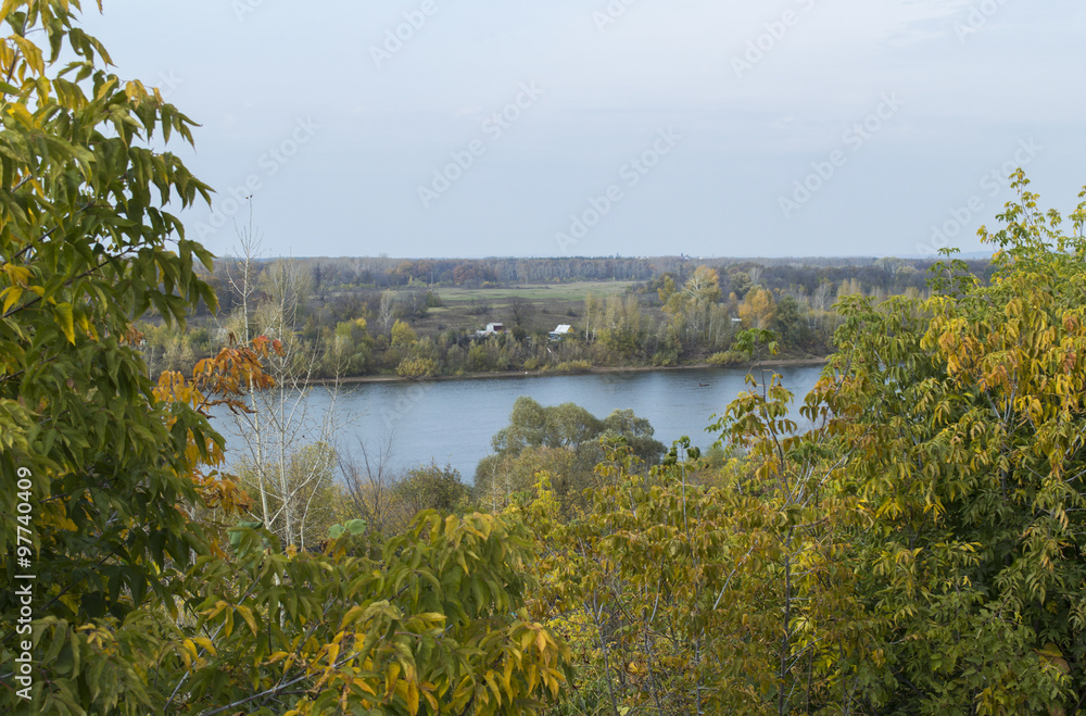 River, open space in the distance and autumn wood