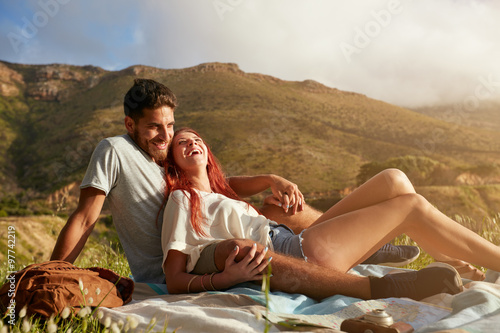 Young couple enjoying picnic on a summer day