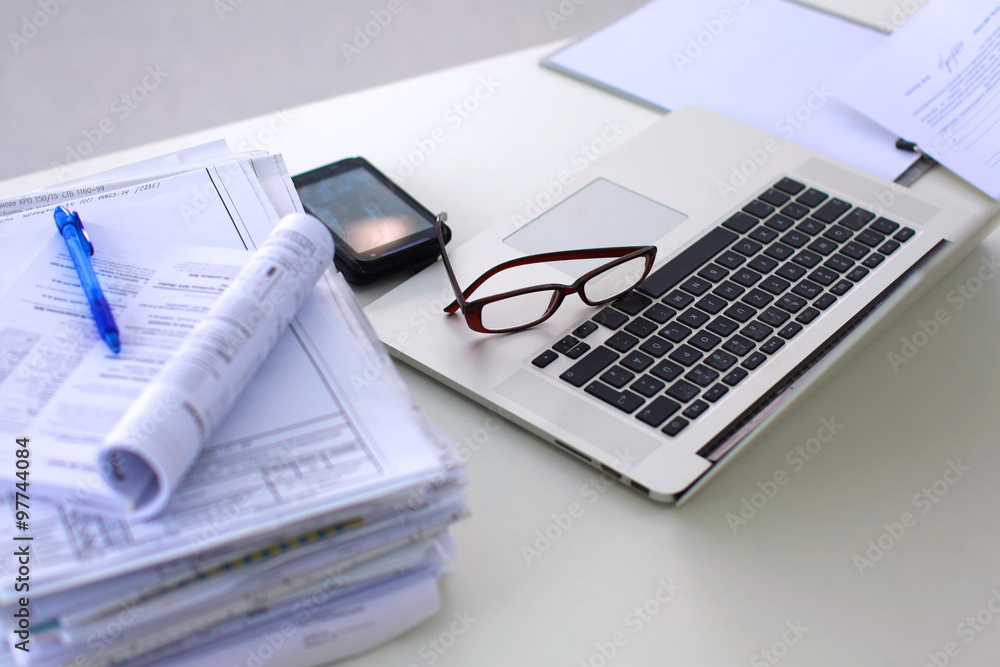 Office table with blank notepad and laptop Office table with blank notepad and laptop