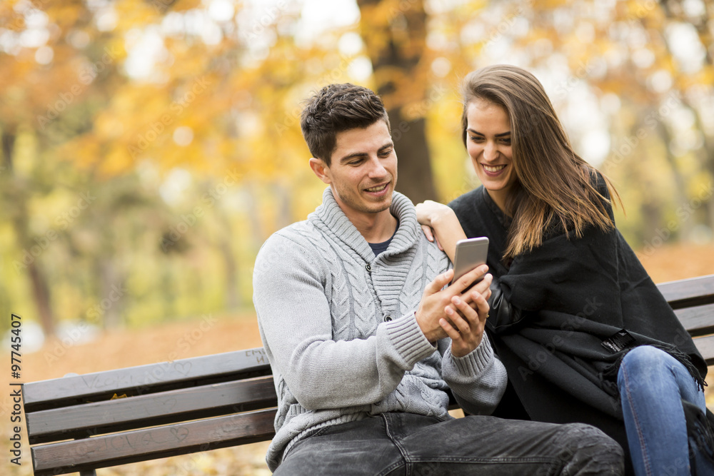 Couple on the bench in the autumn park Couple on the bench in the autumn park