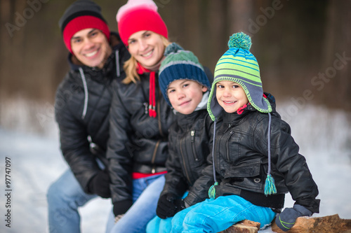Happy family in the winter forest.