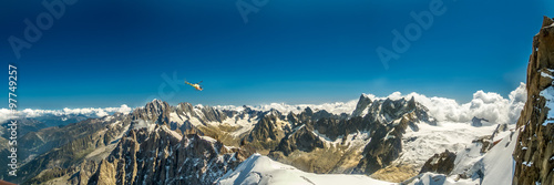 Panoramic view of helicopter flies over a peaks surrounding Mont Blanc 
