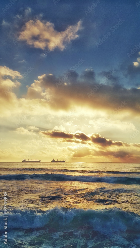 Beautiful sunrise and sailing boats in the sea