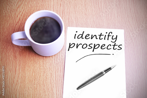 Coffee on the table with note writing identify prospects