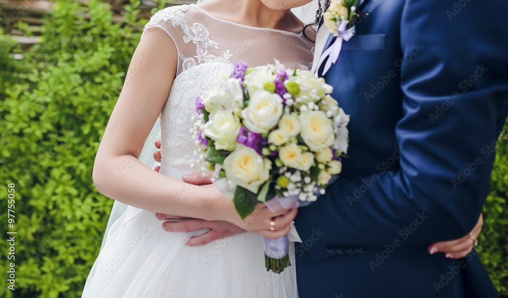 bride and groom posing together outdoors on a wedding day