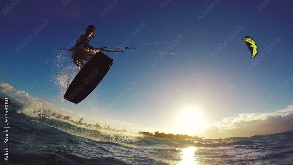Extreme Kitesurfing at Sunset. Summer Ocean Sport in Slow Motion. Girl Kite Surfing in Bikini Extreme Kitesurfing at Sunset. Summer Ocean Sport in Slow Motion. Girl Kite Surfing in Bikini