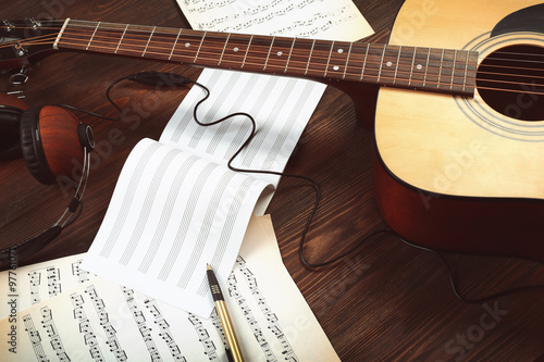 Guitar and music sheets on ...