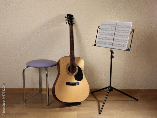 Acoustic guitar propped on ...
