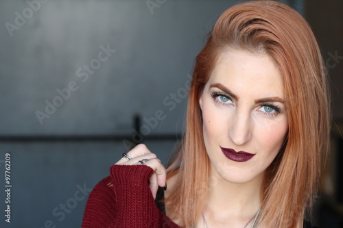 Red-haired girl with intense blue eyes and alternative look  photo