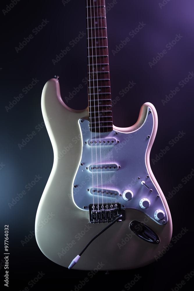 Electric guitar, on dark lighted background