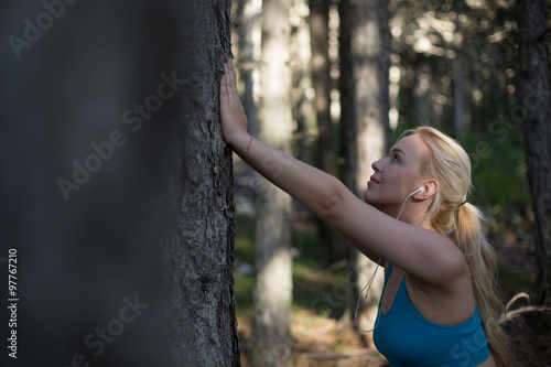 Young woman stretching before running in the early evening