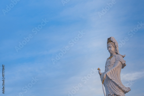 Guanyin Buddha statue on blue sky