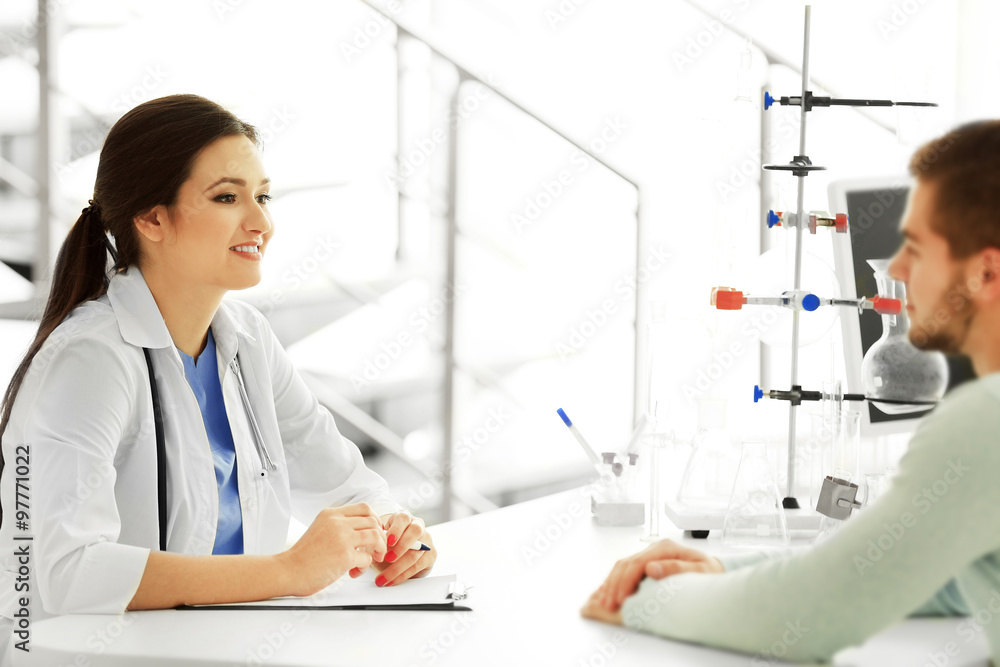 Female doctor examining patient blood pressure Female doctor examining patient blood pressure