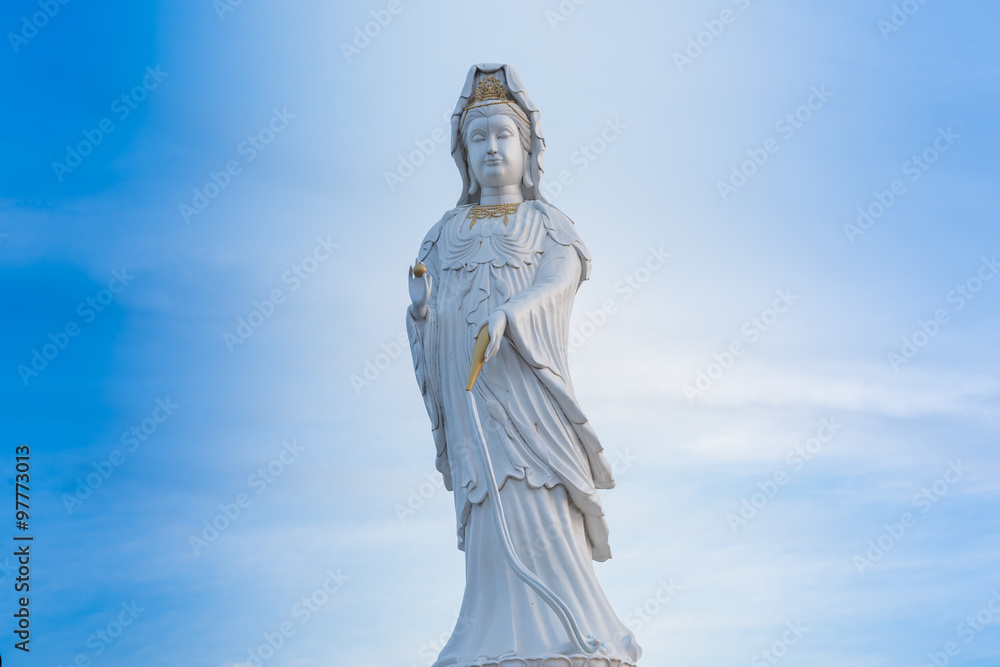 Guanyin Buddha statue on blue sky