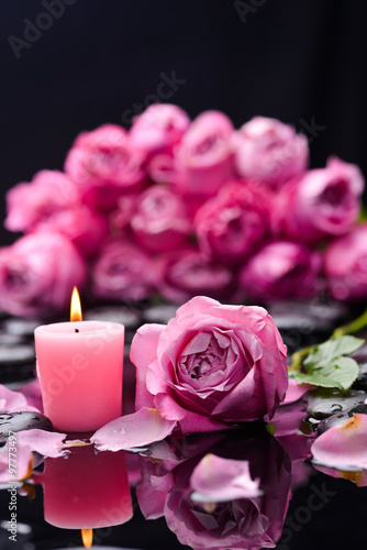 pink rose with candle and therapy stones 
