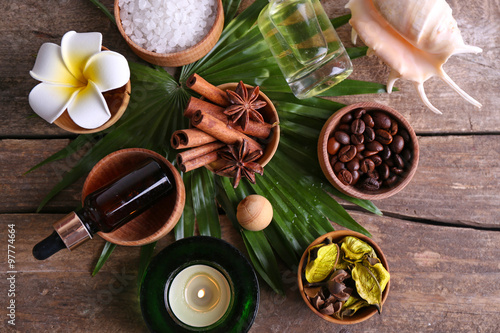 Beautiful spa setting on palm leaf on wooden table photo