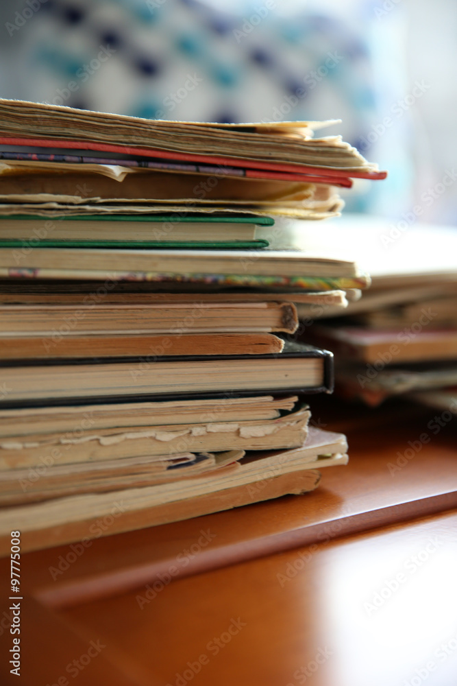 Pile of old books on brown table in the room, close up Pile of old books on brown table in the room, close up