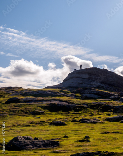 Two people climbing on top of the Haytor in the Dartmoor National Park, Devon, United Kimgdom photo