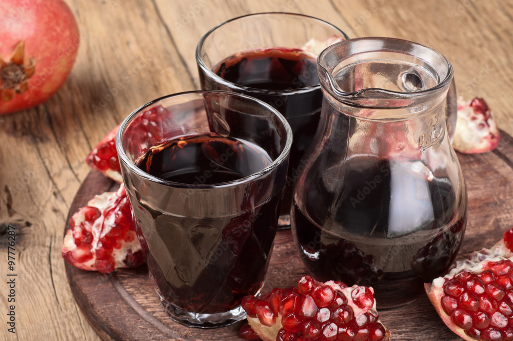 Pomegranate juice on a wooden table closeup. Copy space Pomegranate juice on a wooden table closeup. Copy space