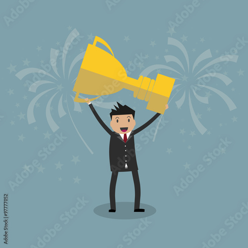 Businessman holding winning trophy