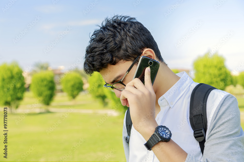 Student with bag talking in phone,outdoor. Student with bag talking in phone,outdoor.