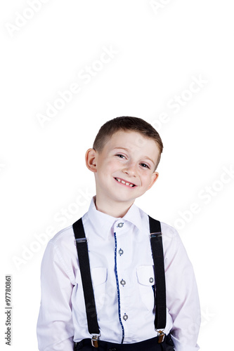 Smiling little boy holding wearing costume with braces.Happy little boy over white background.Smiling, Happy, Joyful beautiful little boy , looking at camera.