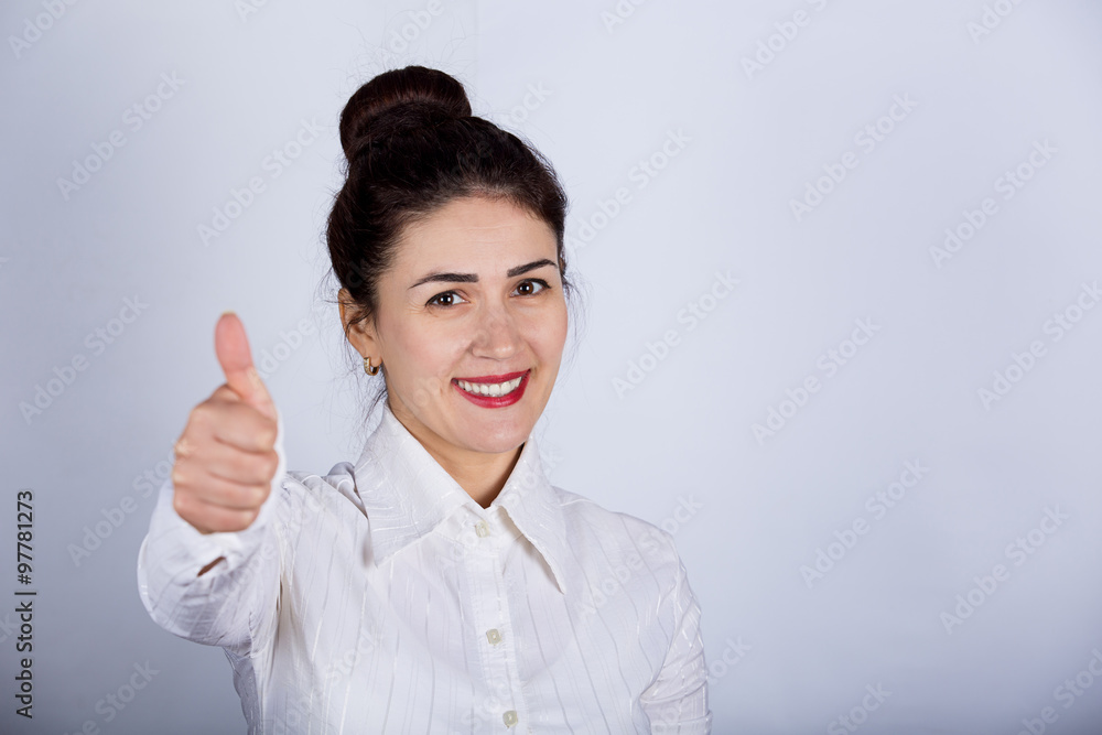 Success business woman excited giving thumbs up.Success woman showing thumbs up.Excited beautiful woman isolated on grey background. Success business woman excited giving thumbs up.Success woman showing thumbs up.Excited beautiful woman isolated on grey background.
