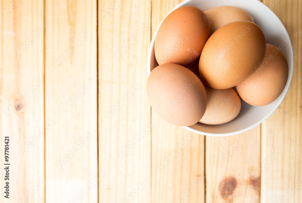 egg in bowl with wood background egg in bowl with wood background