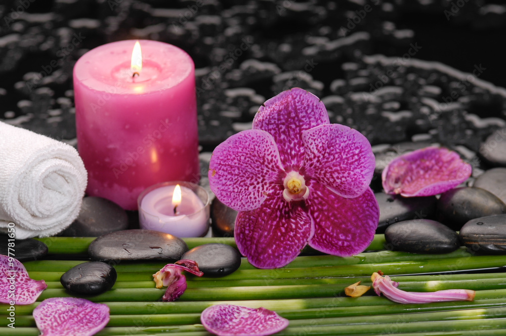 spa concept –orchid and ,stones , towel,candle green long leaf