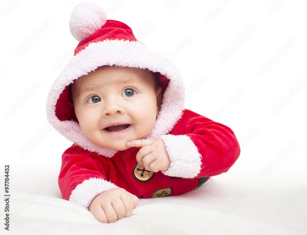 Happy baby lying on tummy wearing a red and white Christmas Santa suit. Happy baby lying on tummy wearing a red and white Christmas Santa suit.