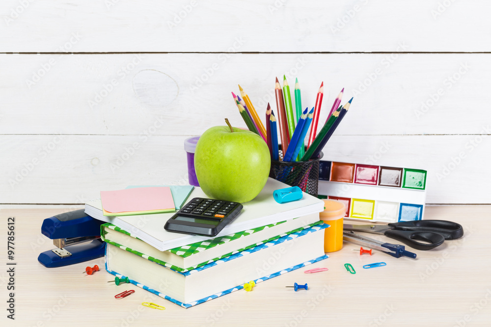 Group of school supplies and books over a white background Group of school supplies and books over a white background