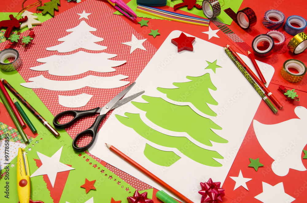 Arts and craft supplies for Christmas. Red and green color paper, pencils,  different washi tapes, craft scissors, cardboard Christmas tree cut and  decorations. Photos