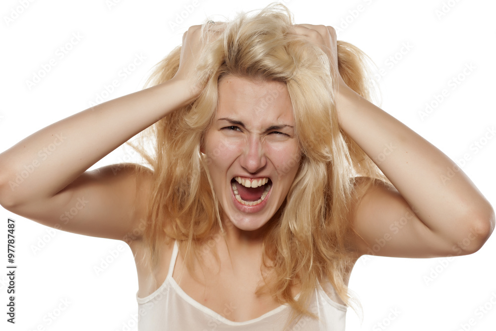 crazy woman pulling her messy hair 