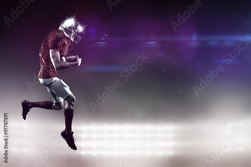 Composite image of american football player holding ball 
