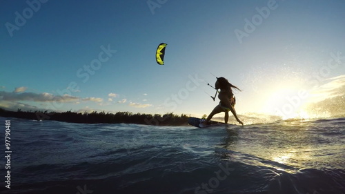 Extreme Kitesurfing at Sunset. Summer Ocean Sport in Slow Motion. Girl Kite Surfing in Bikini 