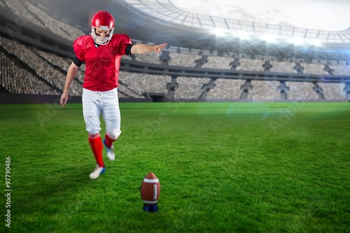 Composite image of american football player kicking football